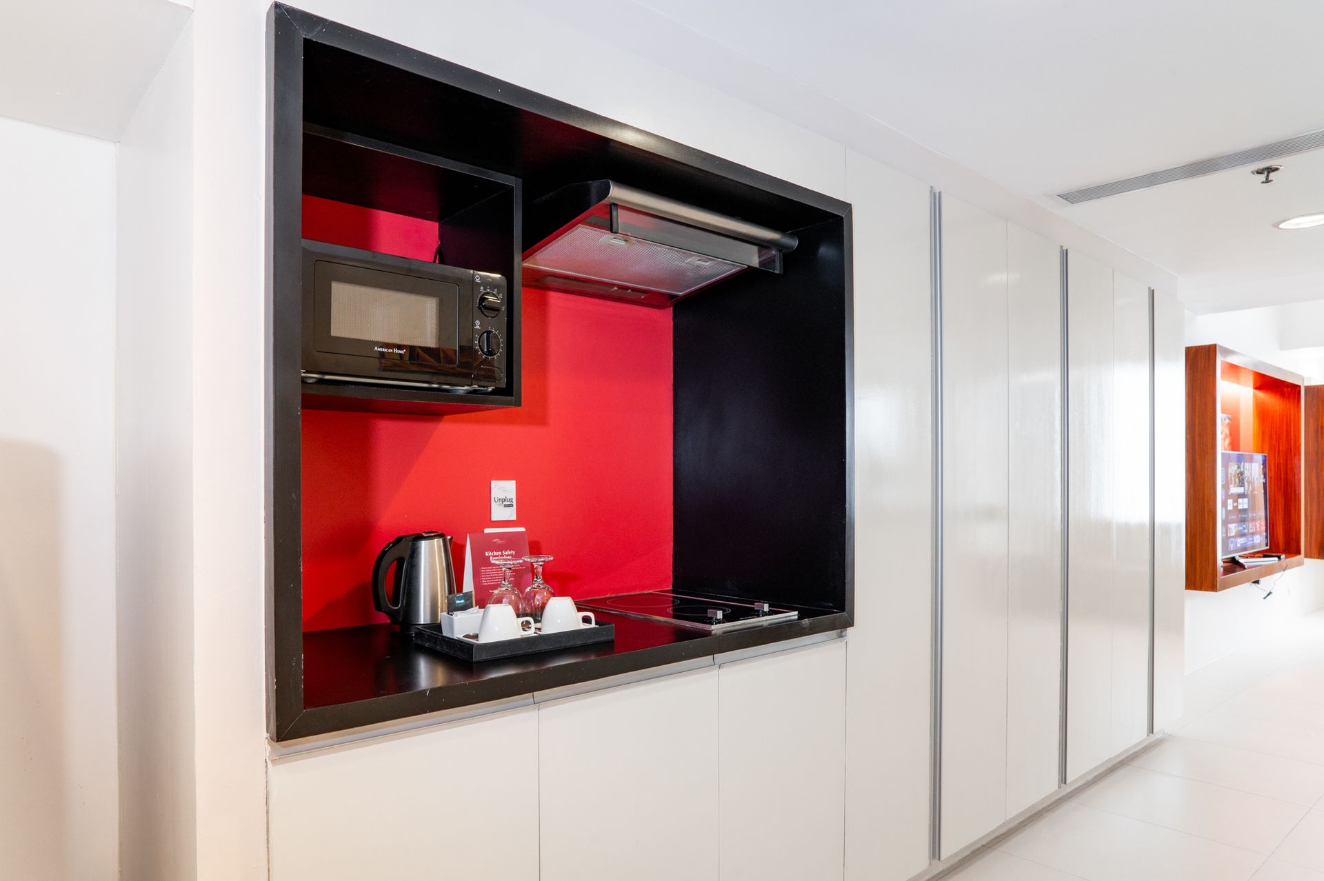 A small kitchen with a microwave and a stove