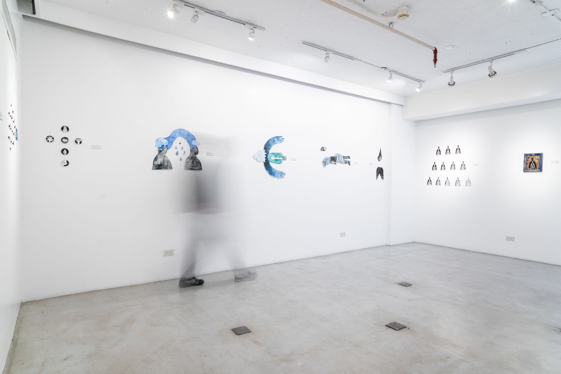 A blurred image of a person walking in an empty room