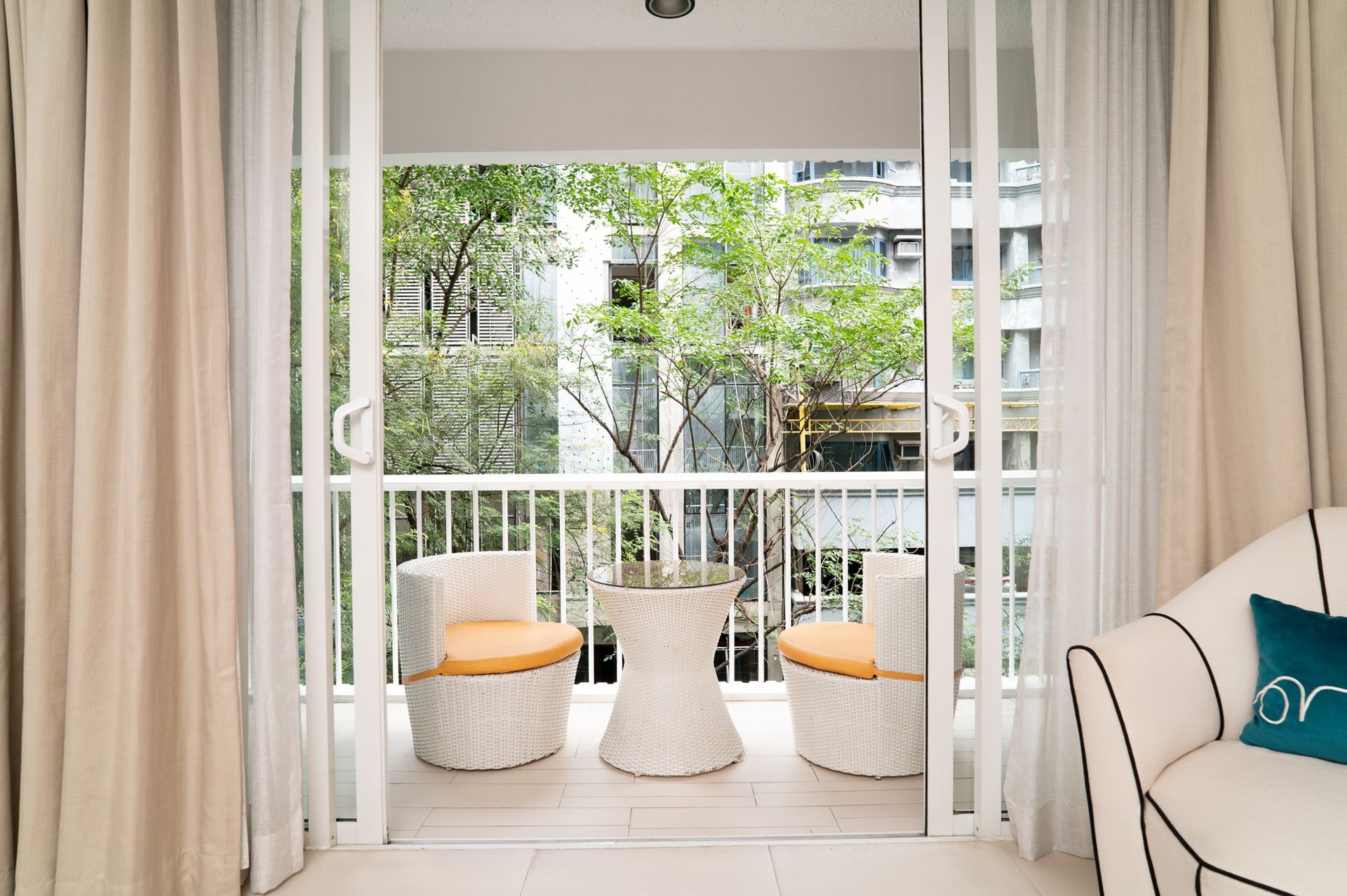 A balcony with chairs and a table in a living room