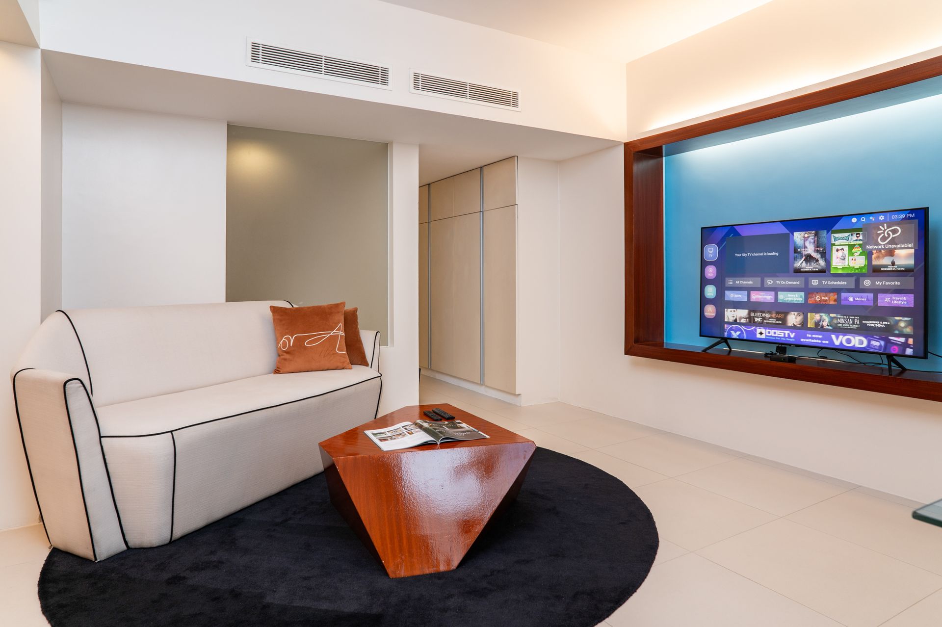 A living room with a couch and a flat screen tv