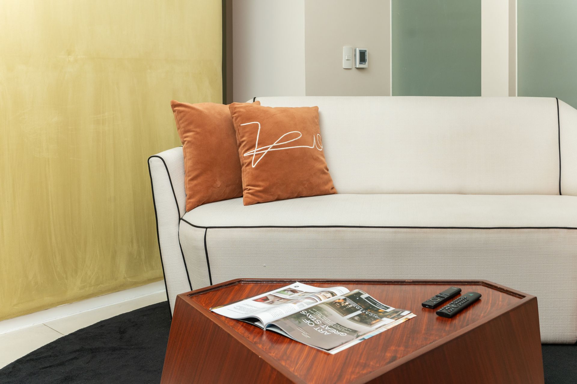 Modern bedroom with orange pillows in Makati