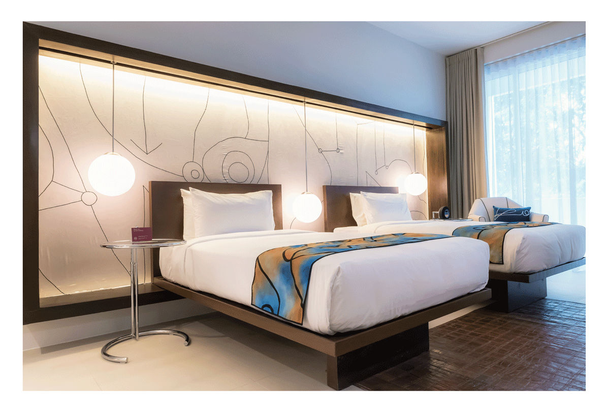 Modern twin bedroom with artistic headboard at Picasso Boutique Residences
