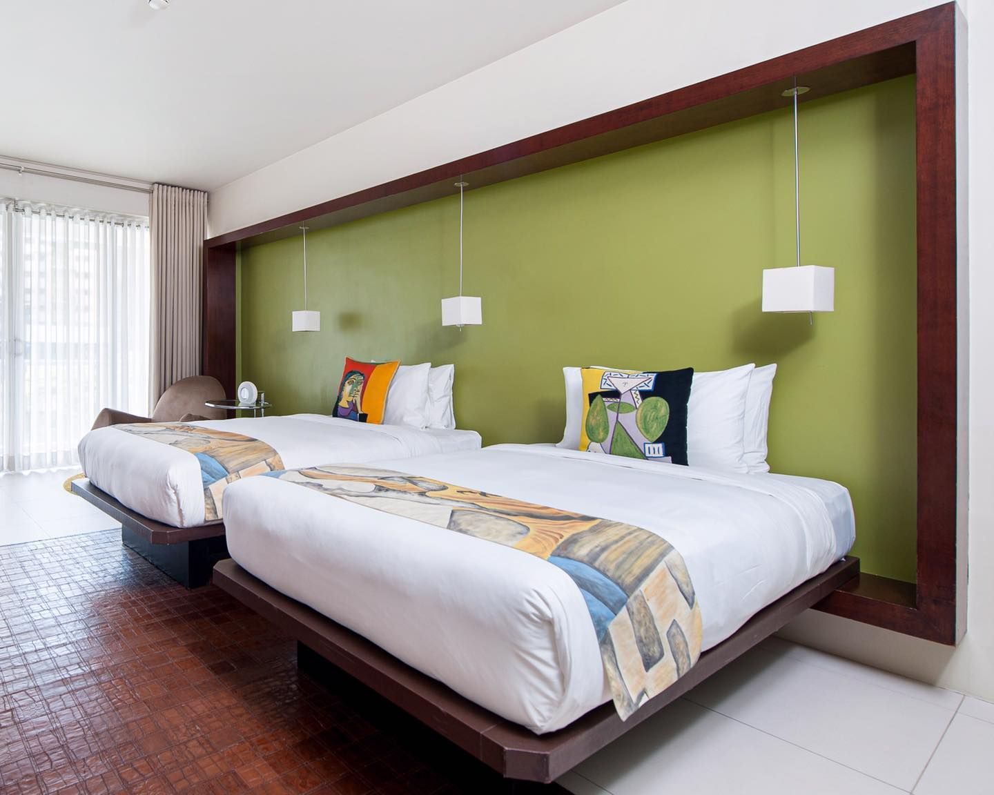 Spacious Andalusia Junior Suite with red accent wall and comfortable sitting area