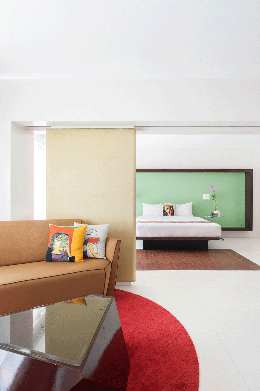 Contemporary lounge with artistic red accents in family-friendly boutique hotel.