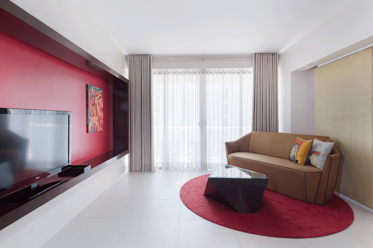 Inviting living room with burgundy wall in boutique serviced residences Makati.