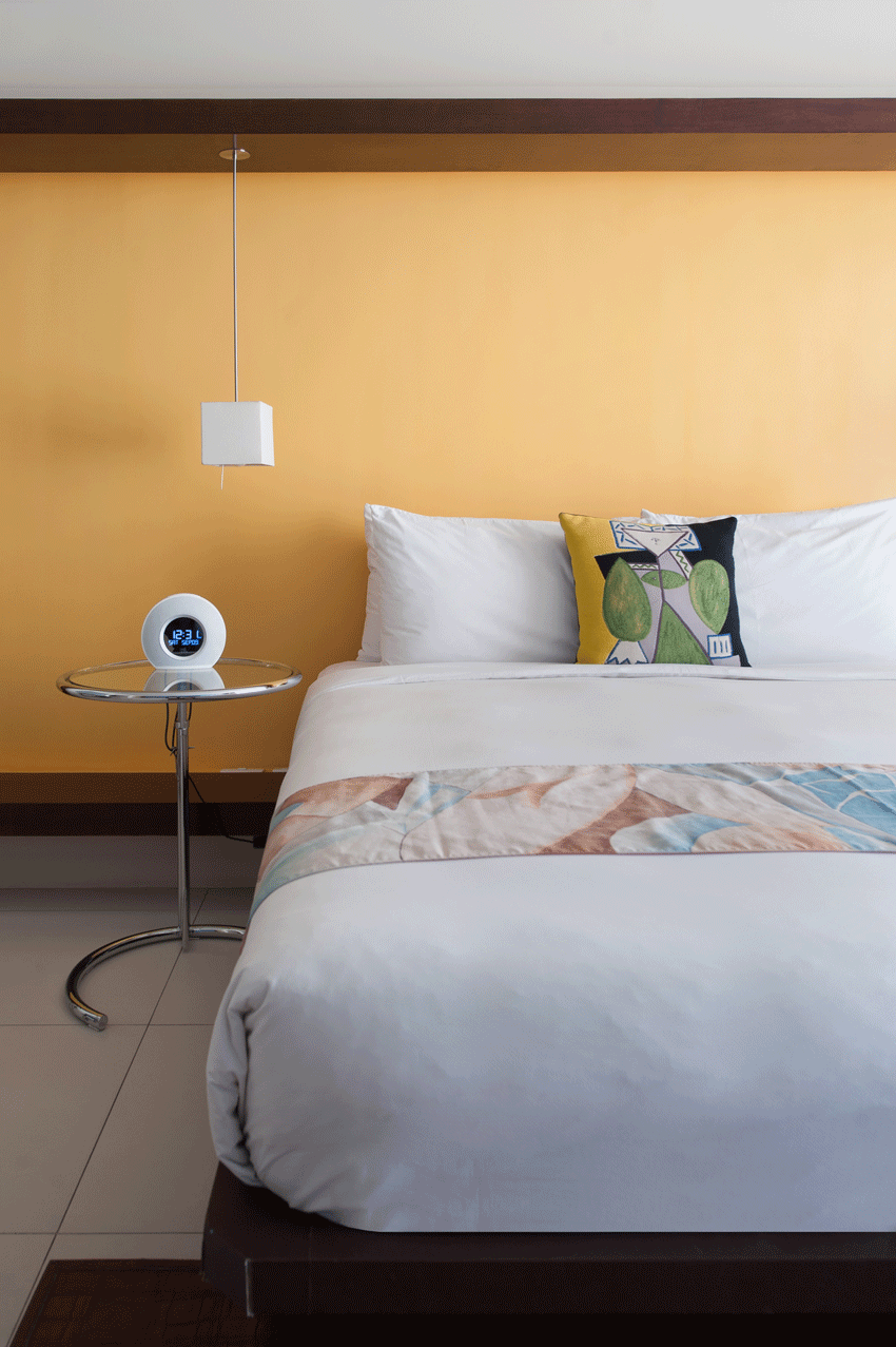 Elegantly appointed bedroom with warm lighting at family-friendly boutique hotel.