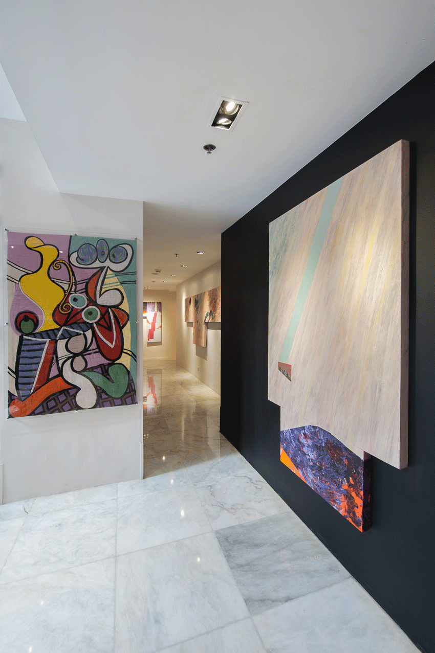 Minimalist lounge area with artwork display at family-friendly boutique hotel.