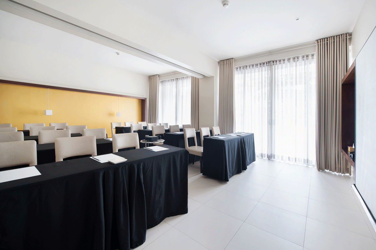 Elegant dining or event space with dark furnishings in family-friendly boutique hotel.