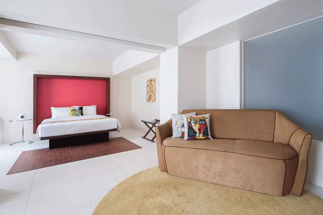 Spacious bedroom with warm lighting at family-friendly boutique hotel Makati.