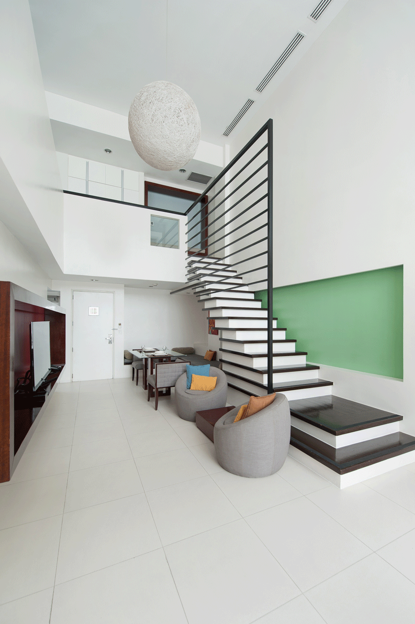 Modern loft workspace with green wall and kitchenette in boutique serviced residences Makati.