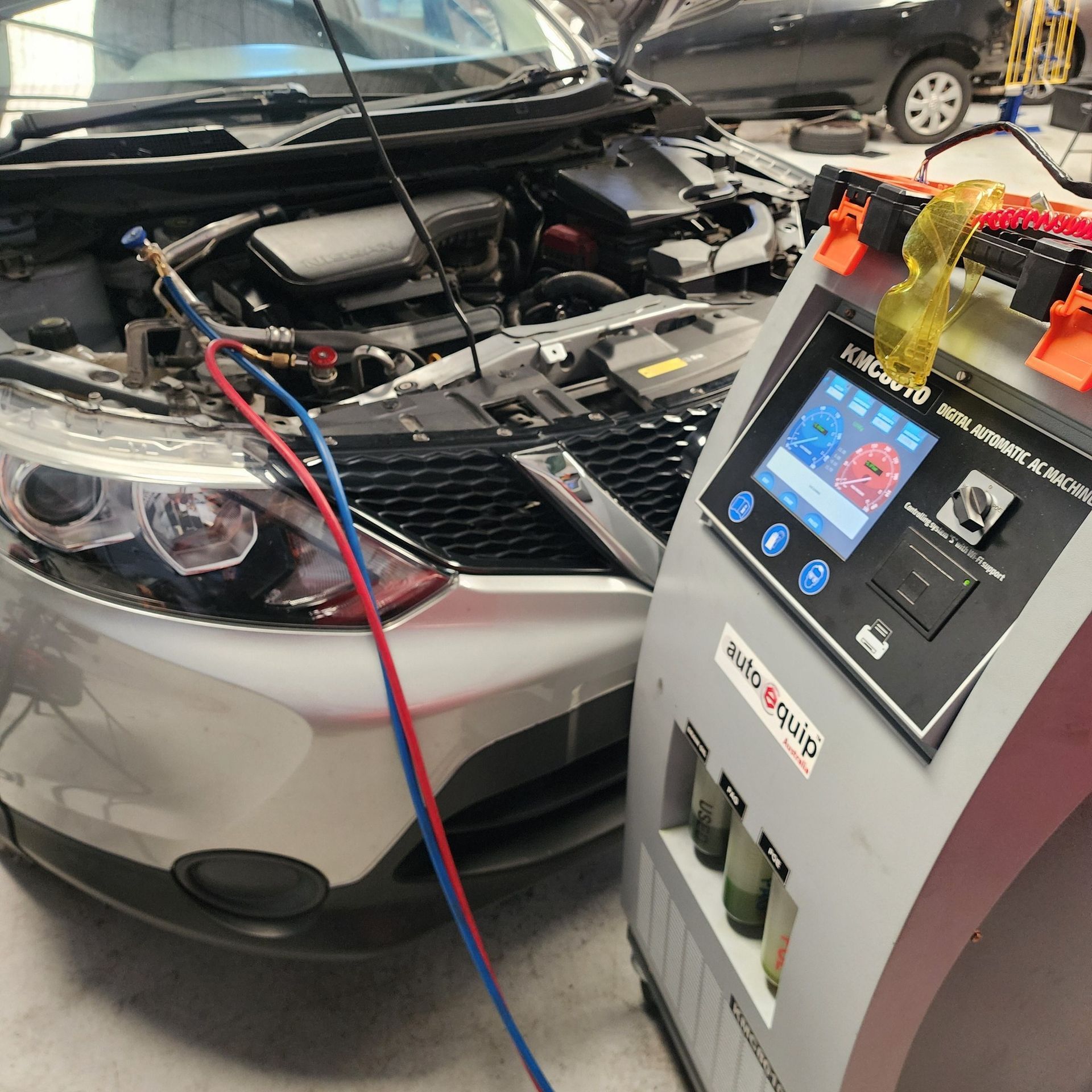 Silver Car With Open Hood Connected to Ac Service Machine in a Garage — QA Oxley in Seventeen Mile Rocks, QLD