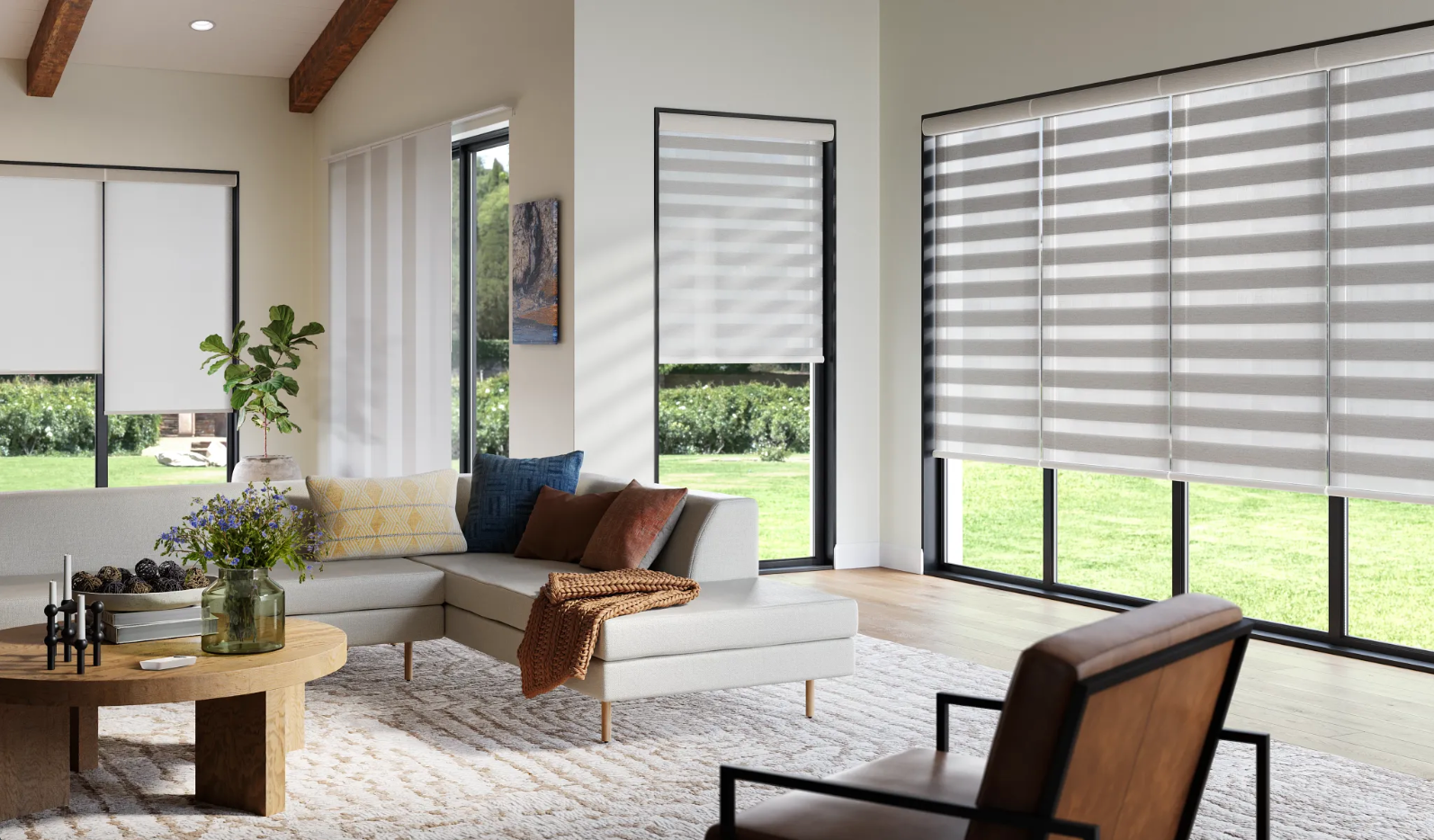 A living room with a couch , chair , table and striped blinds.