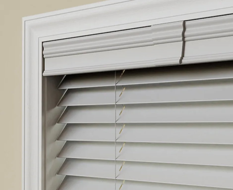 A close up of a white blind on a window