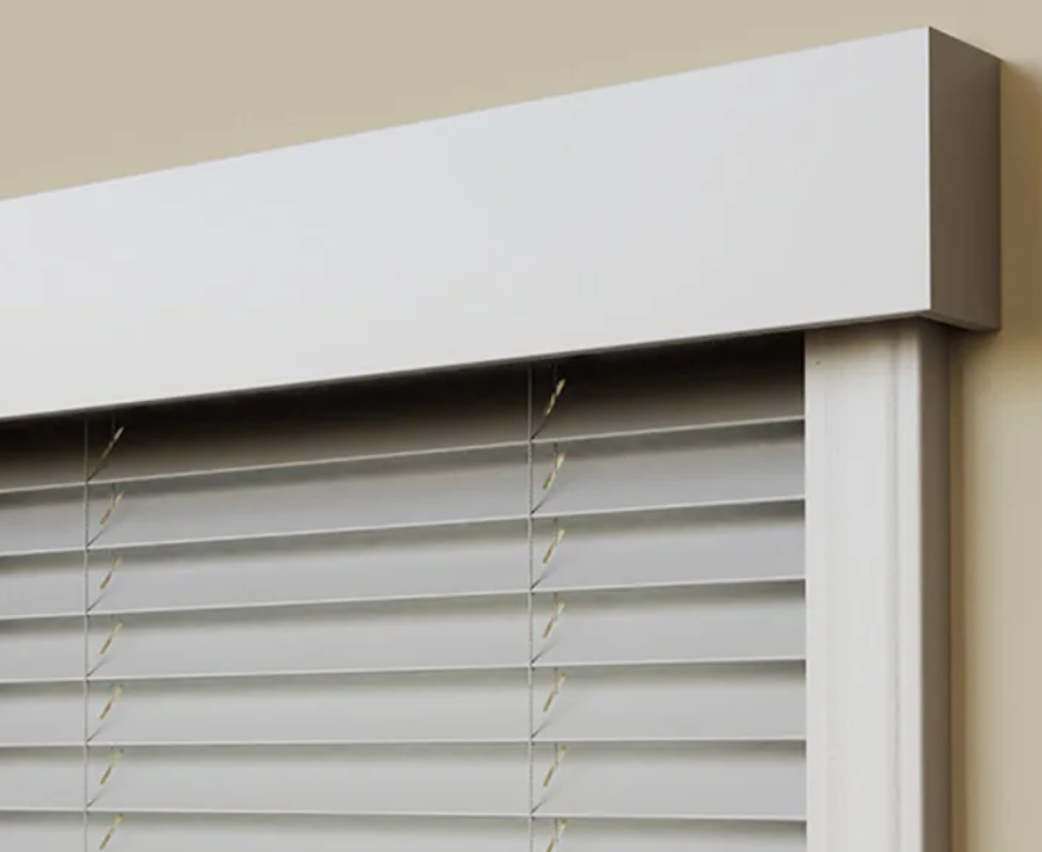 A close up of a window with blinds and a white trim