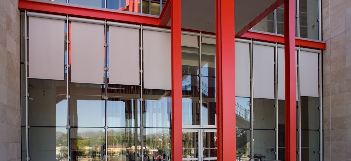 Hunter Douglas patio shades are seen on the outside of a building.