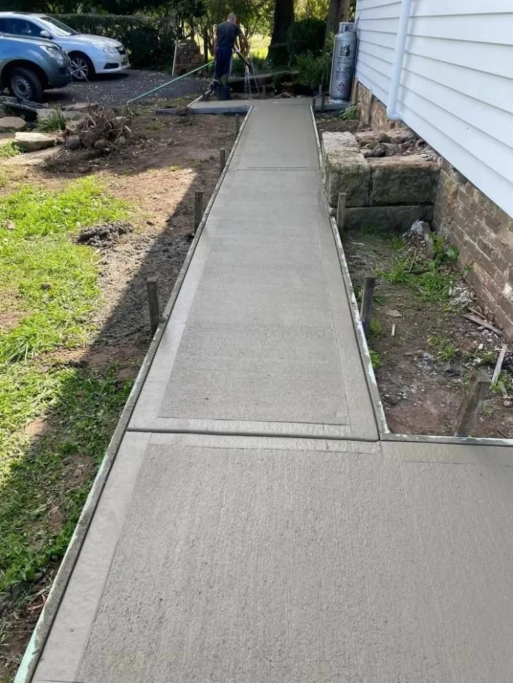 Fresh Concrete Walkway Along a House Under Construction — BJ's Concreting in North Nowra, NSW