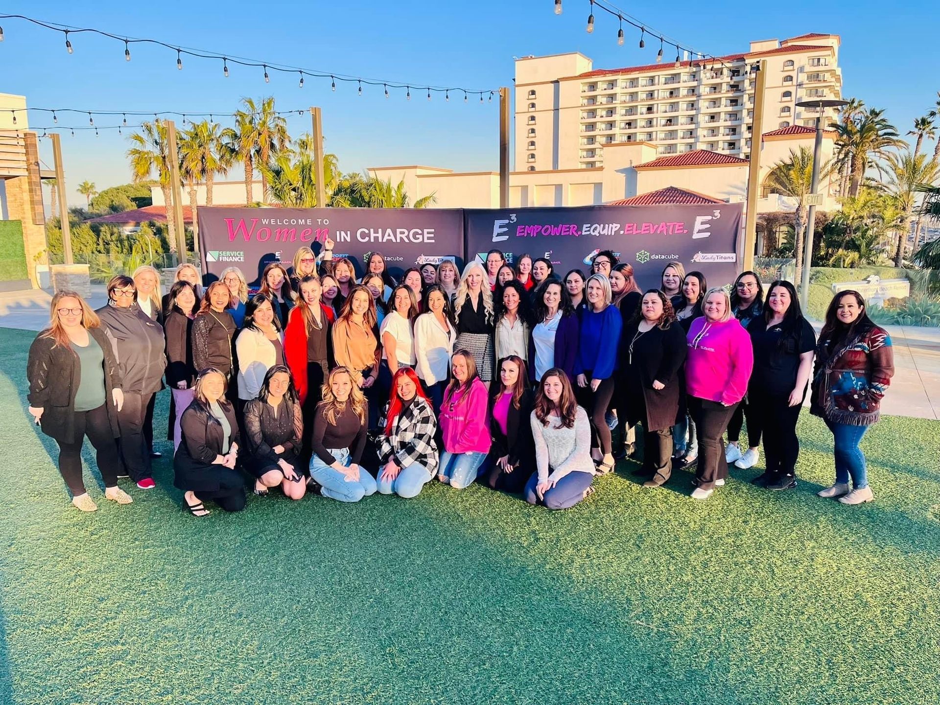 A large group of women are posing for a picture in a park.