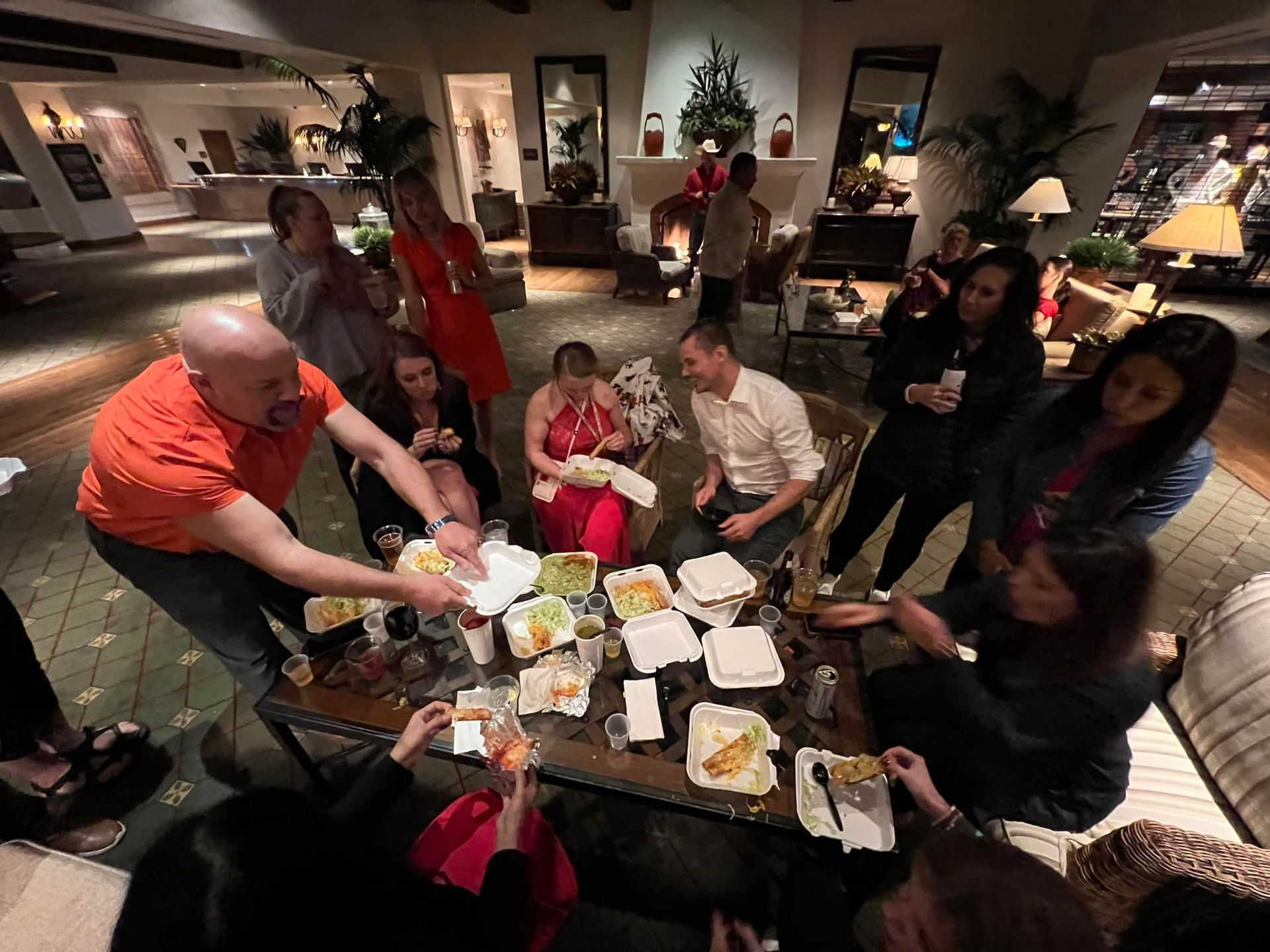A group of people are sitting around a table eating food