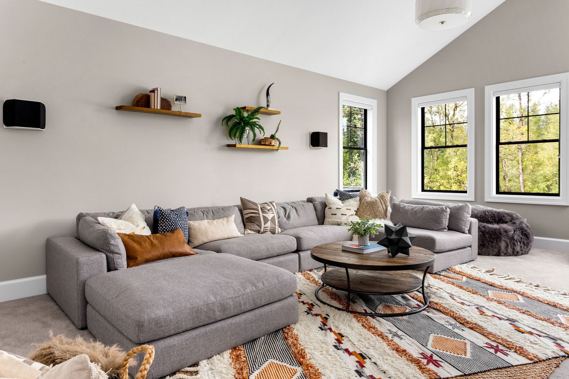A living room filled with furniture and a rug.