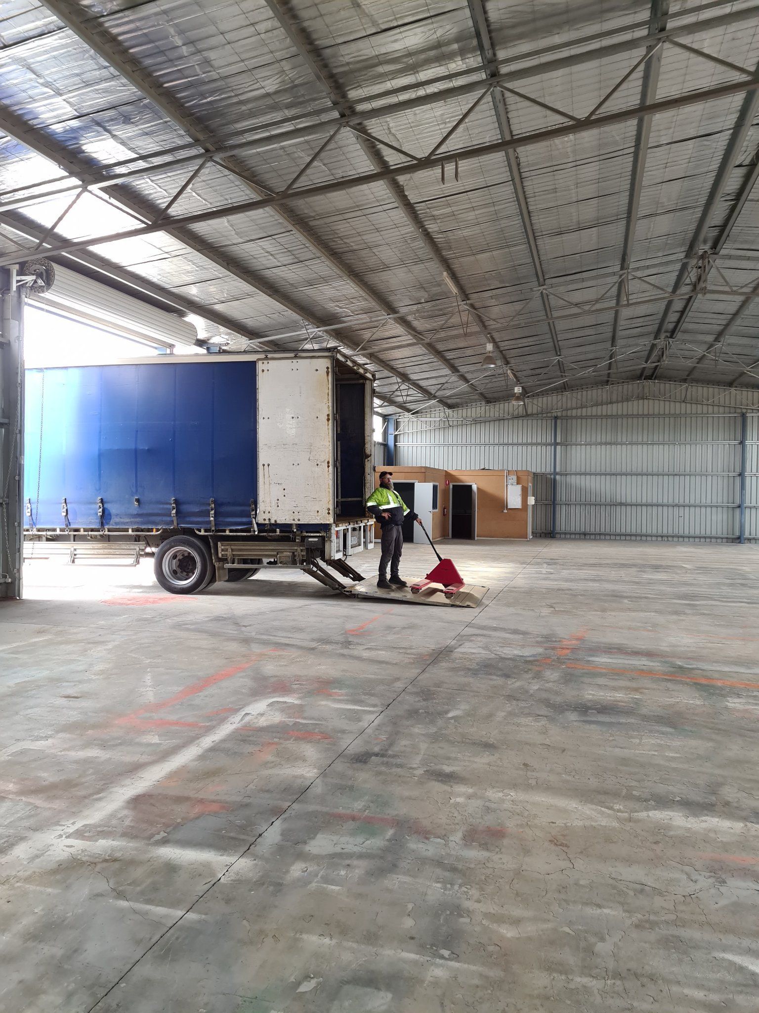 Worker loading truck in warehouse