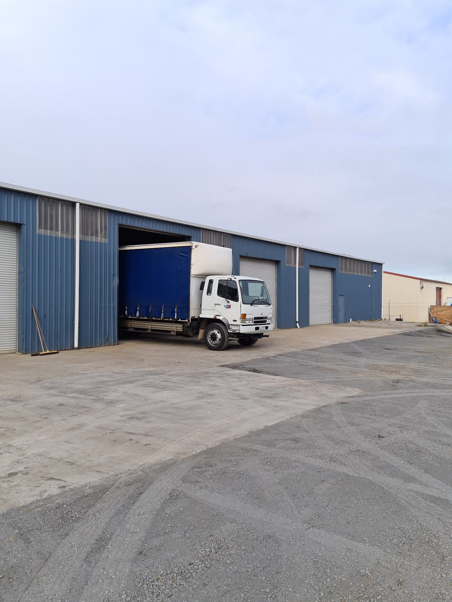 White truck parked in blue warehouse