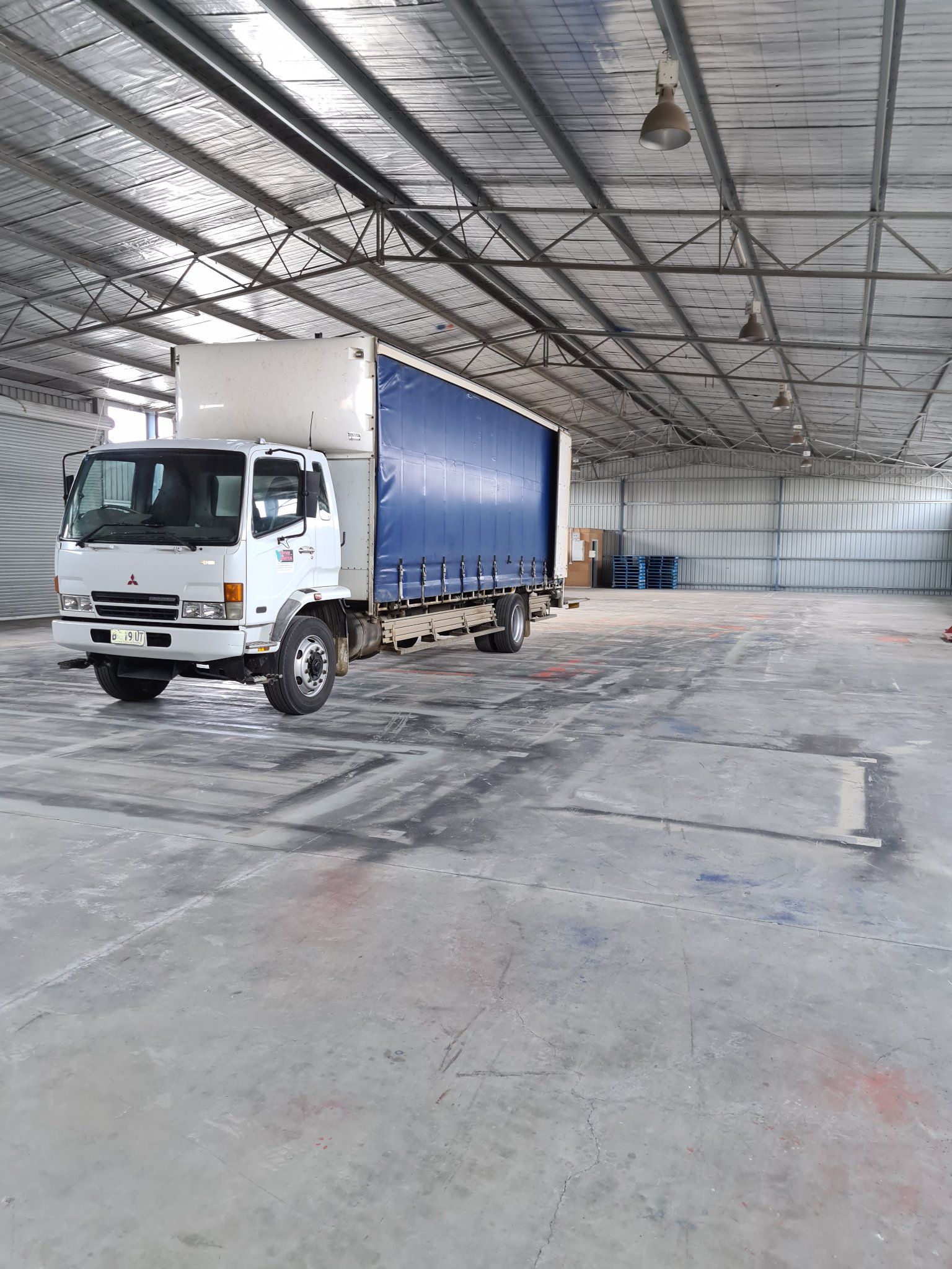White truck in a large warehouse