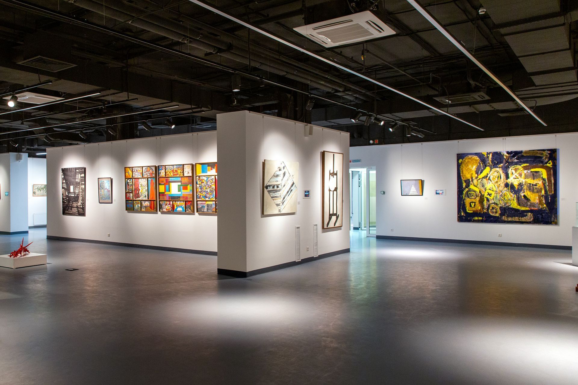 Modern artwork hanging in a magnolia coloured gallery