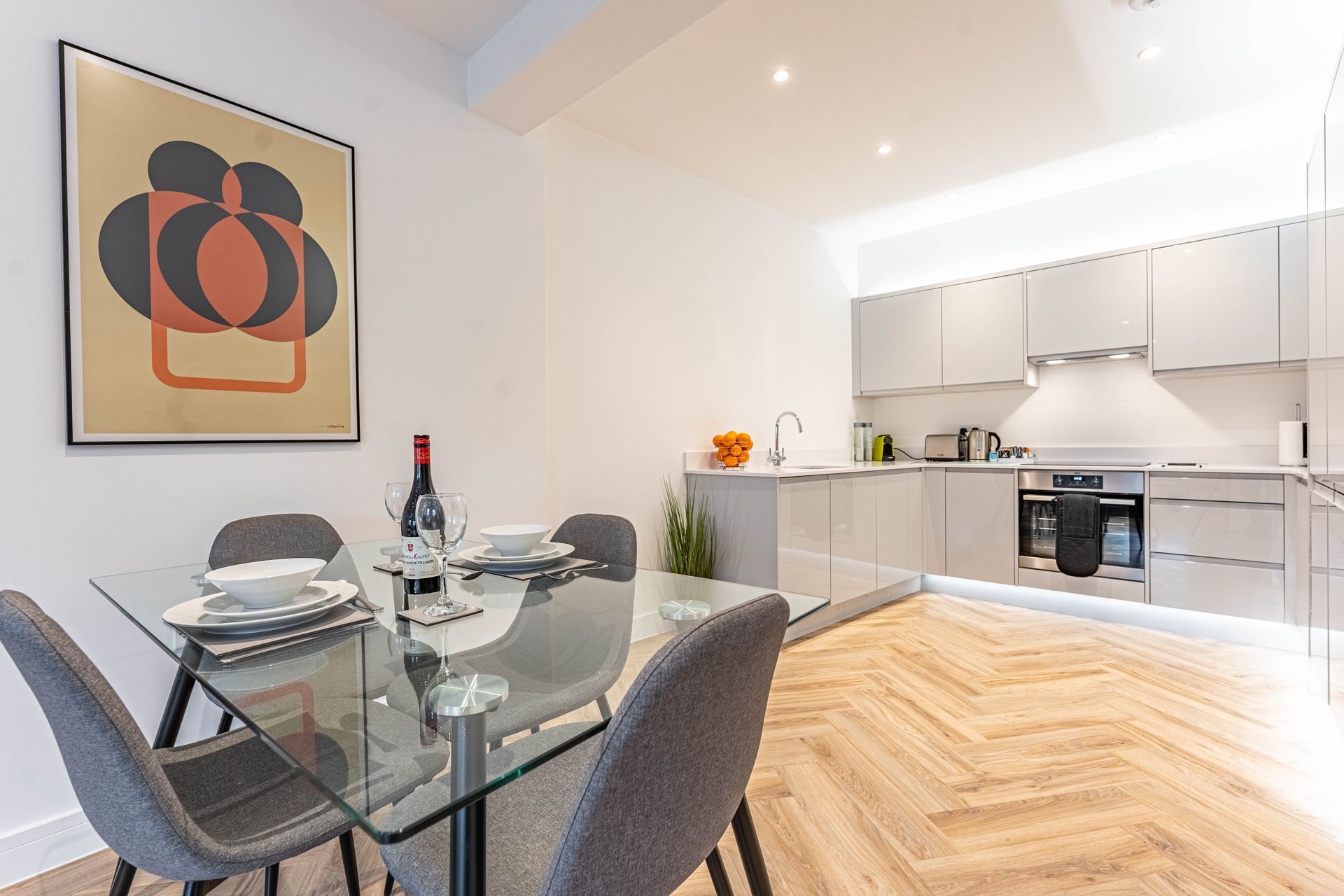 Wellington house open plan kitchen leading to the dining room with a wine bottle on the table