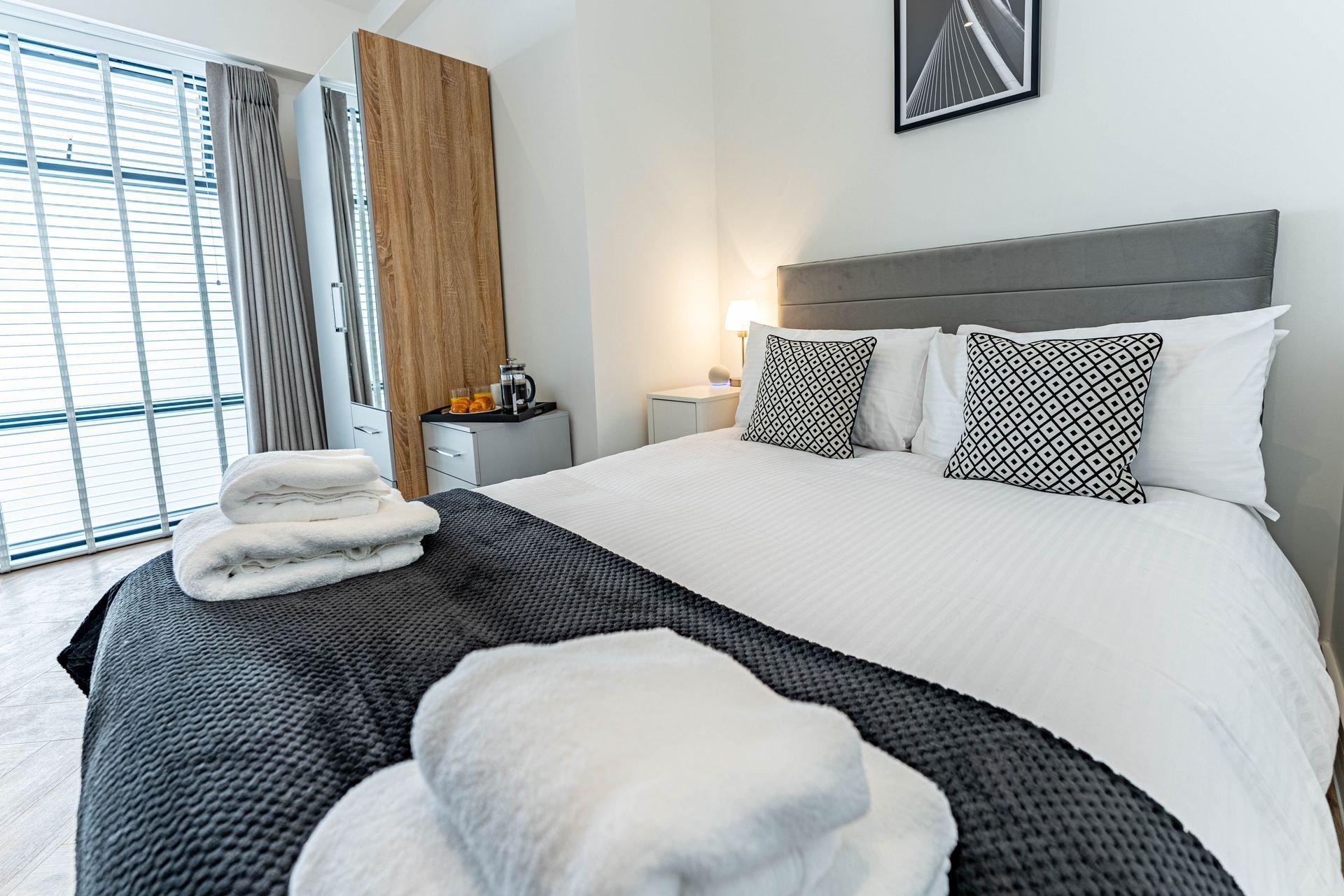 wellington house bedroom with double bed and towels folded on each side