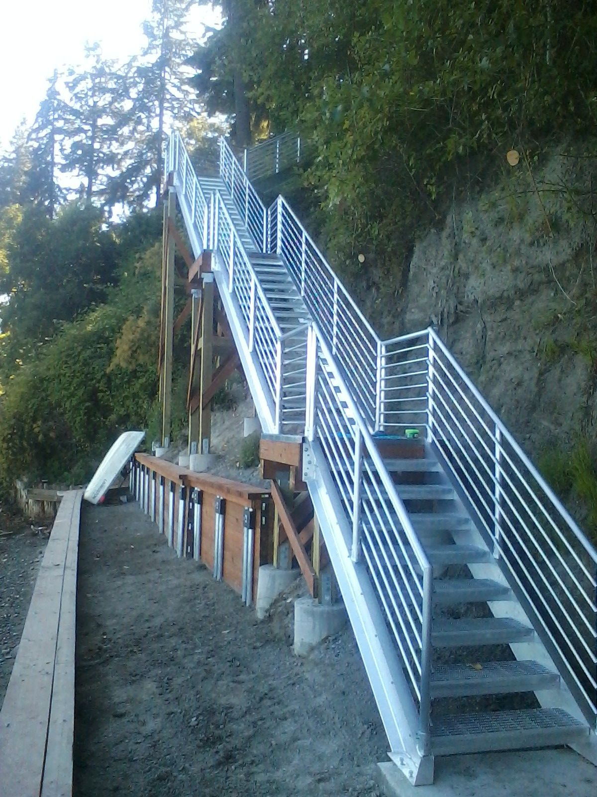 Custom aluminum staircase stringers laid out in the fabrication shop