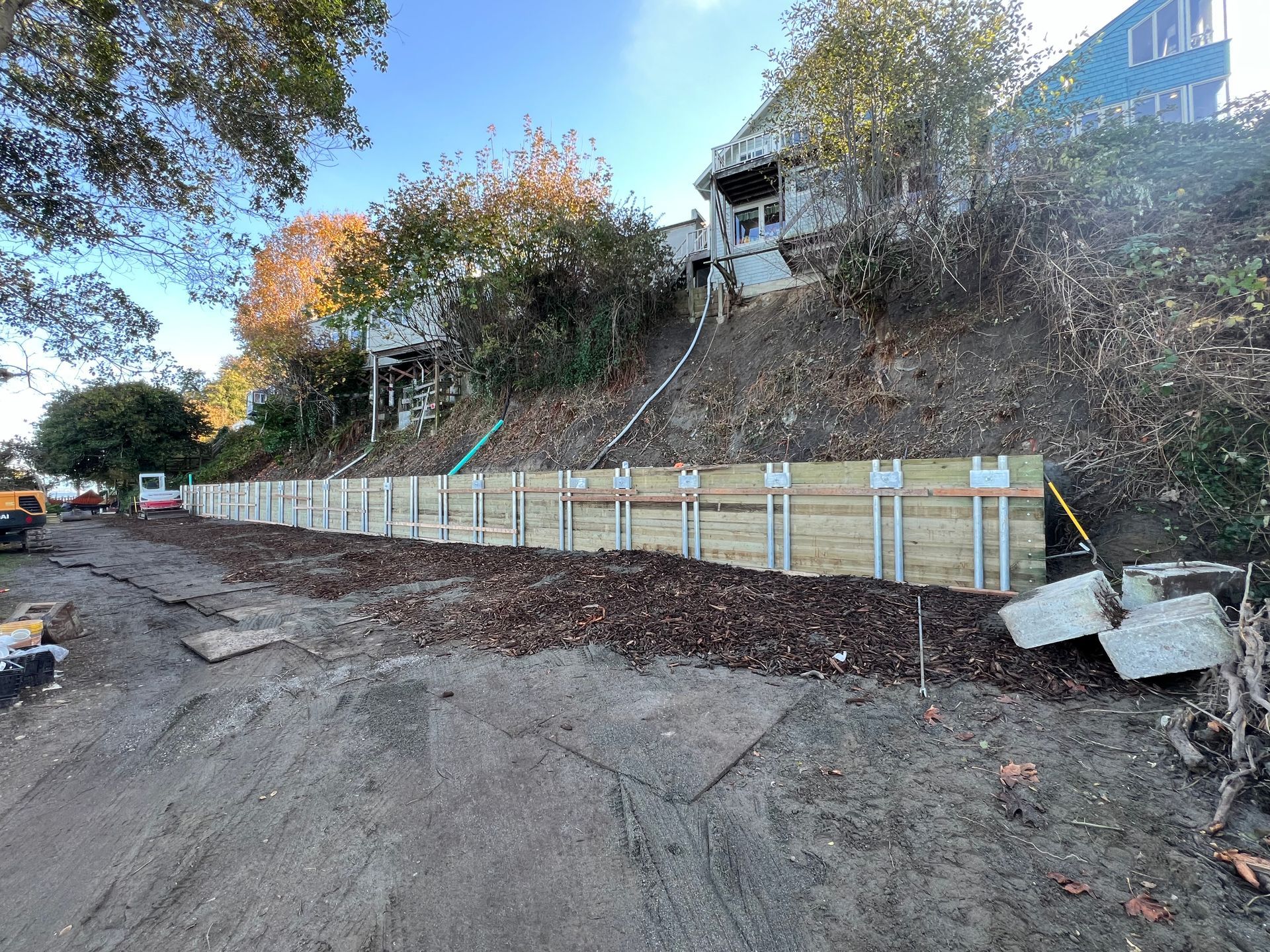 Completed soldier pile wall below residential property on terraced coastal lot