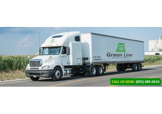 White Green Line semi-truck on a road, transporting goods. Green logo and phone number on the trailer.