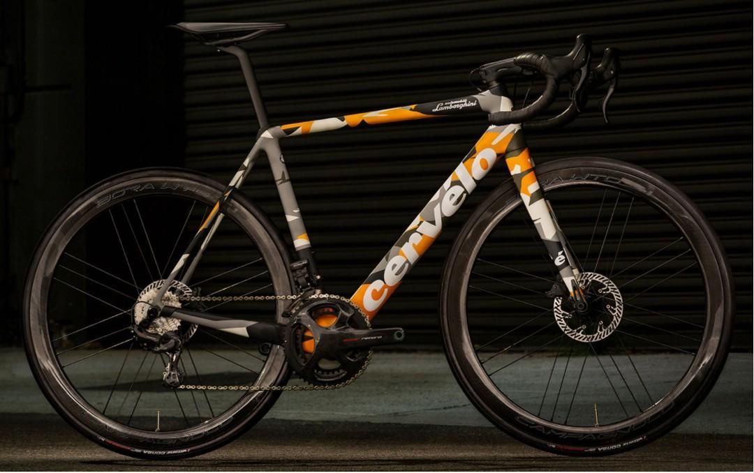 A Black And Orange Bicycle Is Parked In Front Of A Building — Trinity Cycle Works In Cairns City, QLD