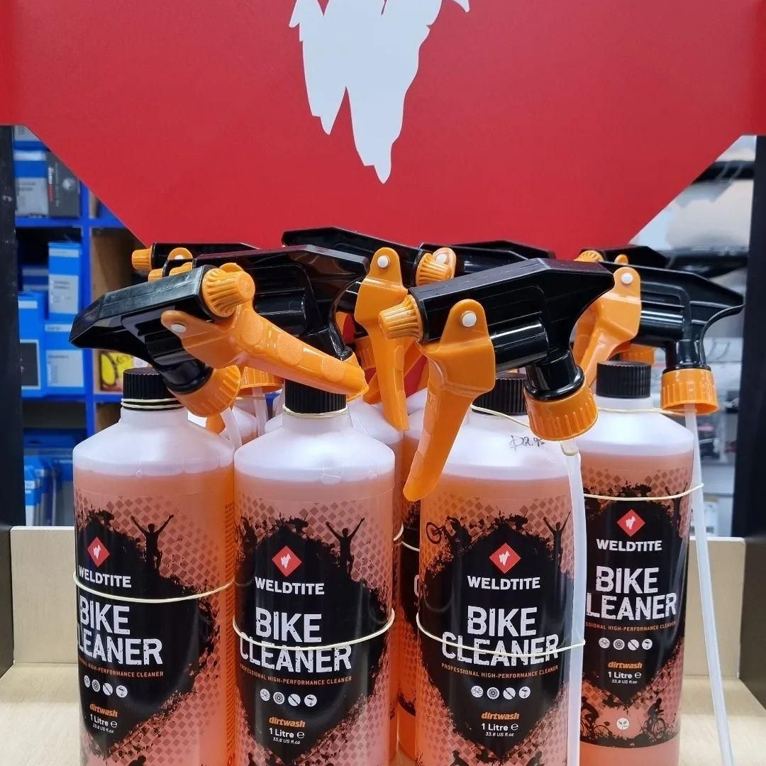 Several Bottles Of Bike Cleaner Are Lined Up On A Table — Trinity Cycle Works In Cairns City, QLD