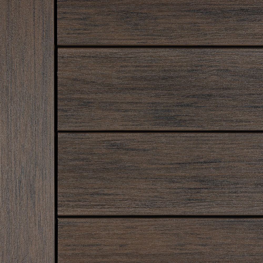 Close-up of dark brown wood paneling with horizontal slats and a vertical trim strip