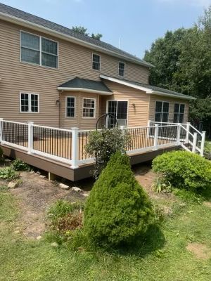 A large house with a large deck in front of it.