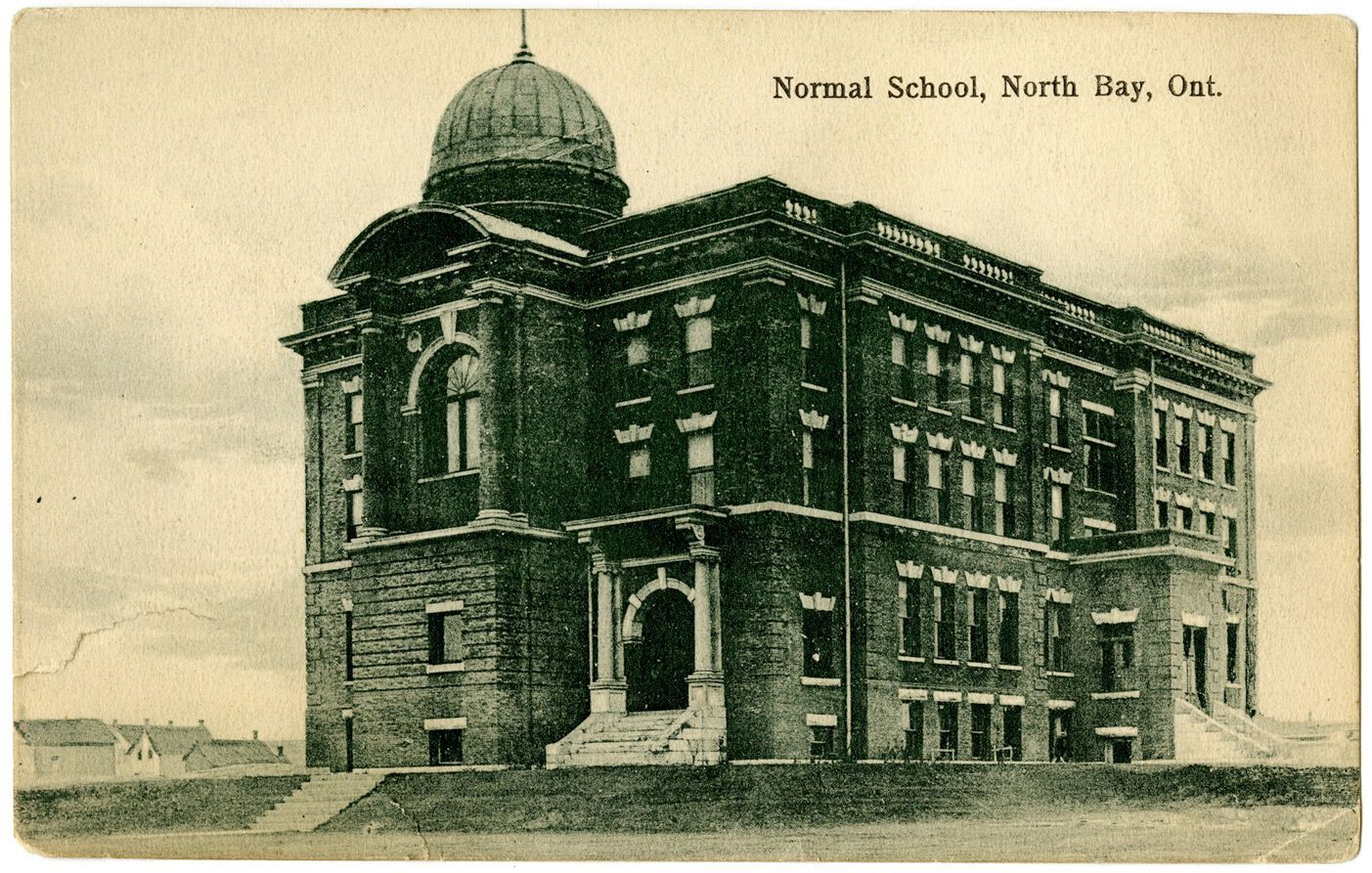 Normal School building in North Bay, Ontario, with a domed roof, brick facade, and arched entrance.