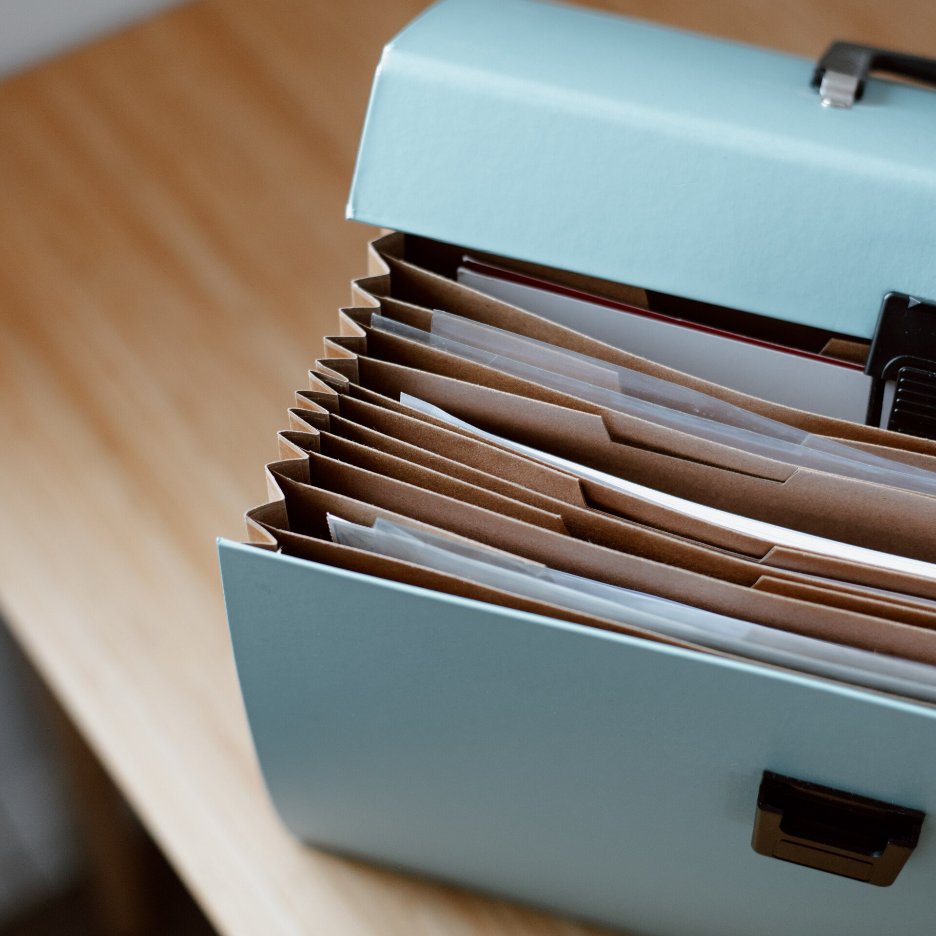 a blue briefcase filled with folders and papers
