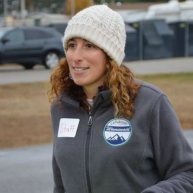 A woman wearing a Catamount Womenaid fleece is smiling.