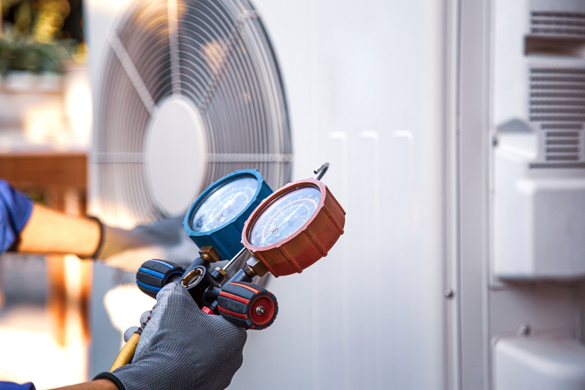Expert HVAC service contractor diagnosing an outdoor AC unit with pressure gauges and a checklist. Two service technicians standing beside a van with tools and equipment.