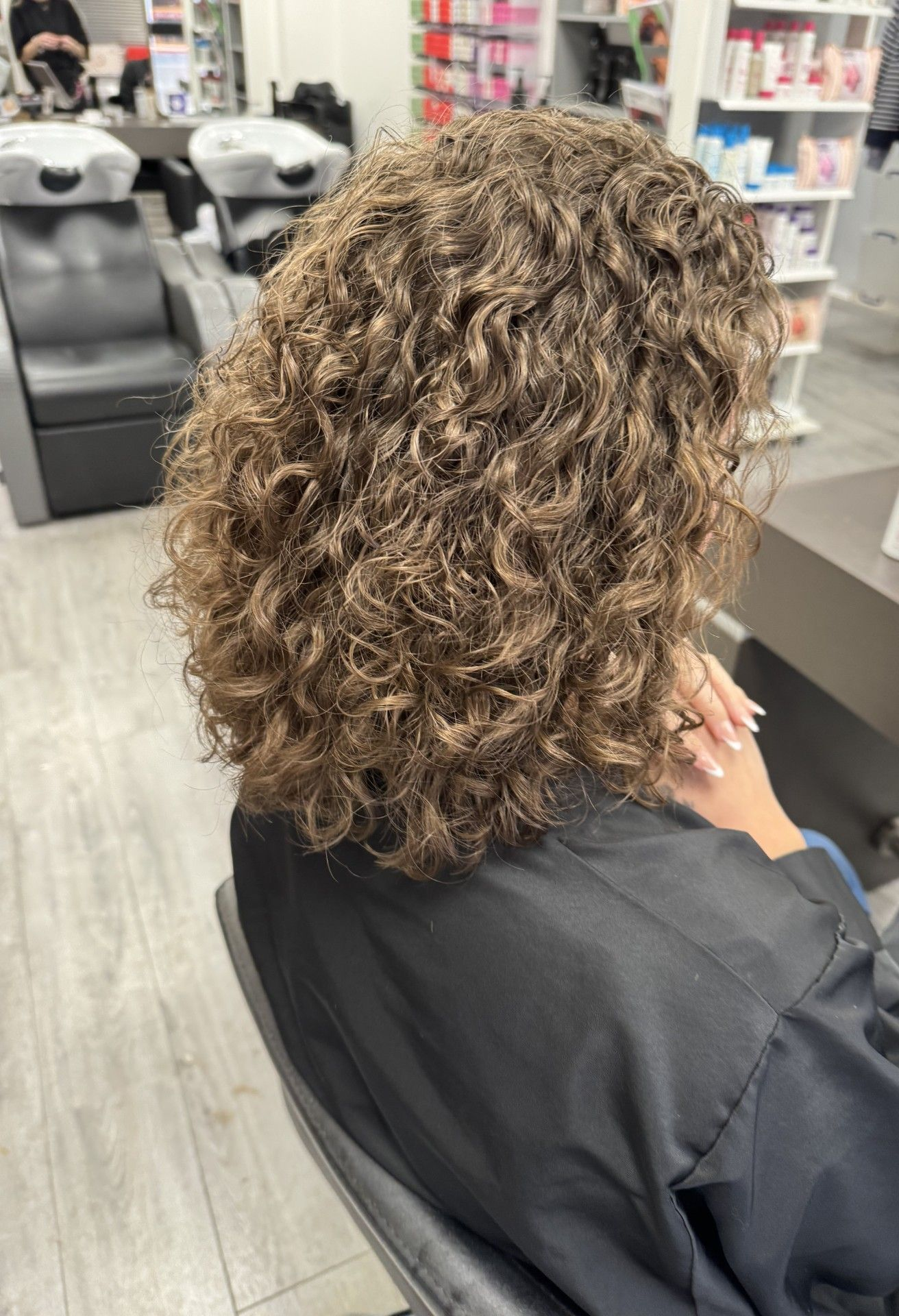 Finished perm result showing restored curl after professional aftercare support