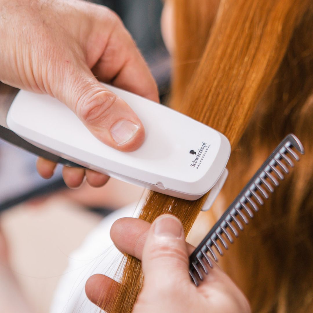 SalonLab Smart Digital Hair Analyzer being used to assess a section of hair