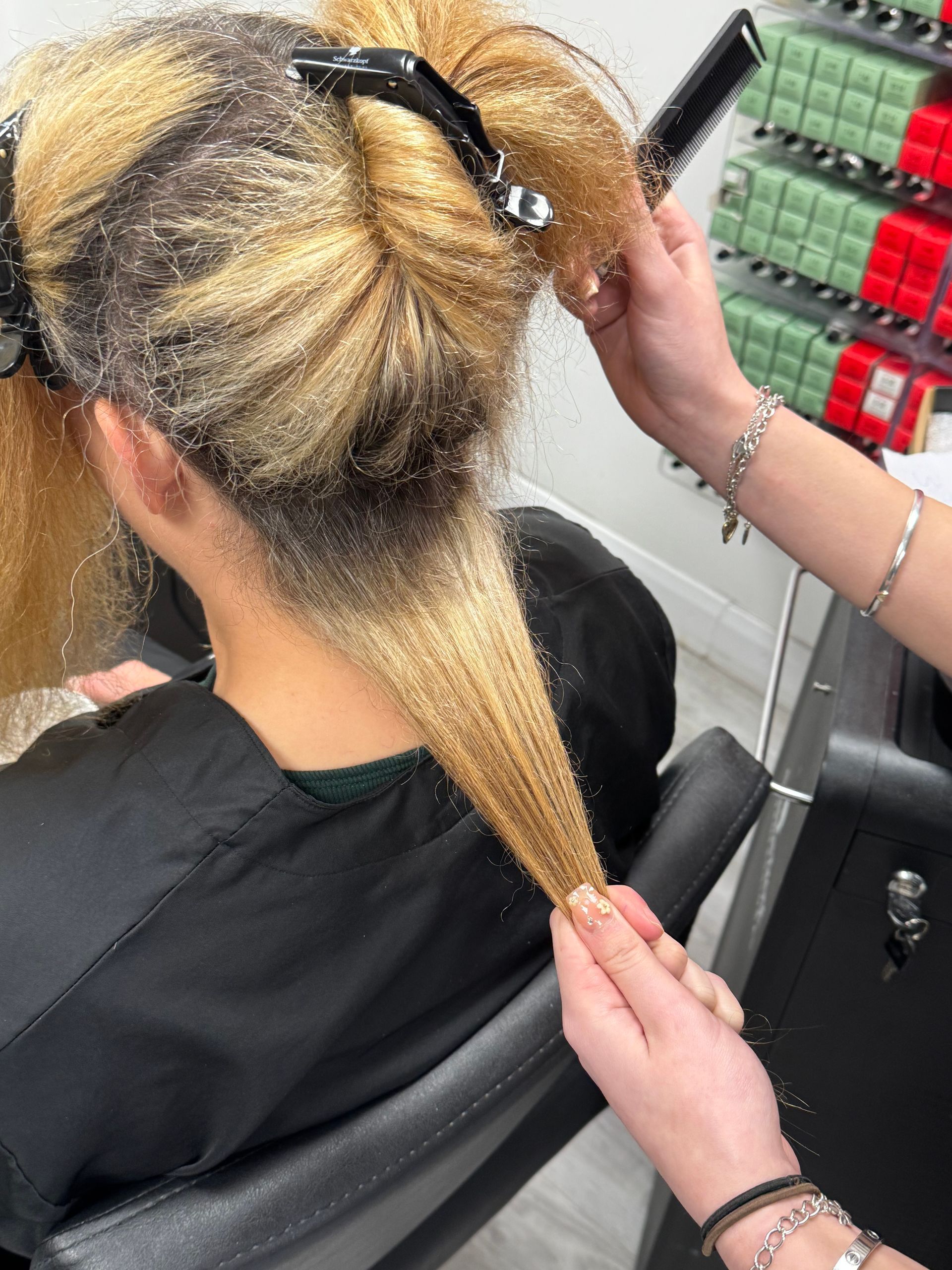 Stylist assessing hair condition and colour history during a professional consultation