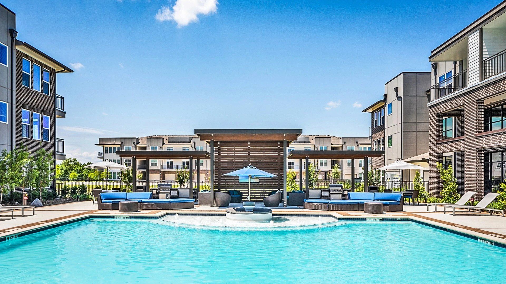 There is a large swimming pool in the middle of a building.