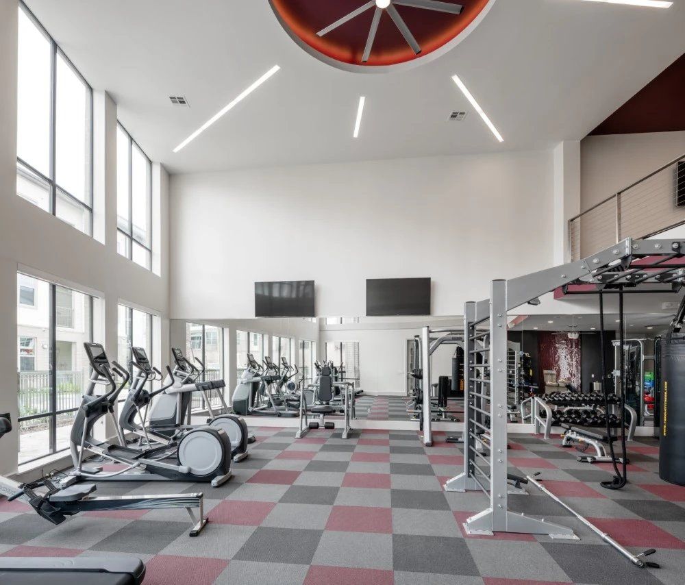 A large gym with a clock on the ceiling