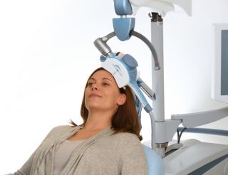 woman using a transcranial magnetic stimulation device