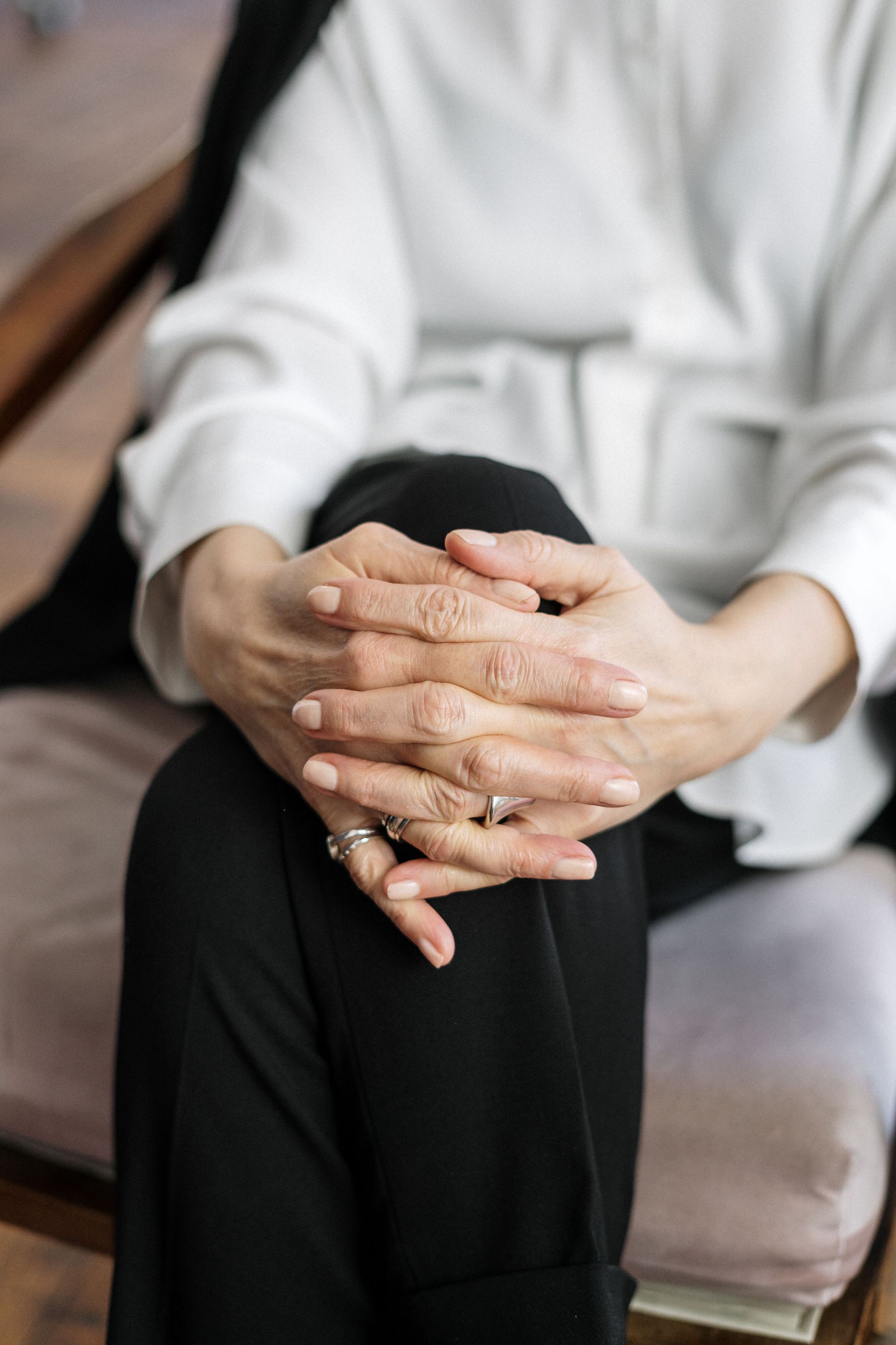Hands pressing on a person's lower back during a massage treatment