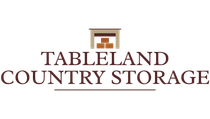 The logo for tableland country storage shows a storage shed with boxes in it.