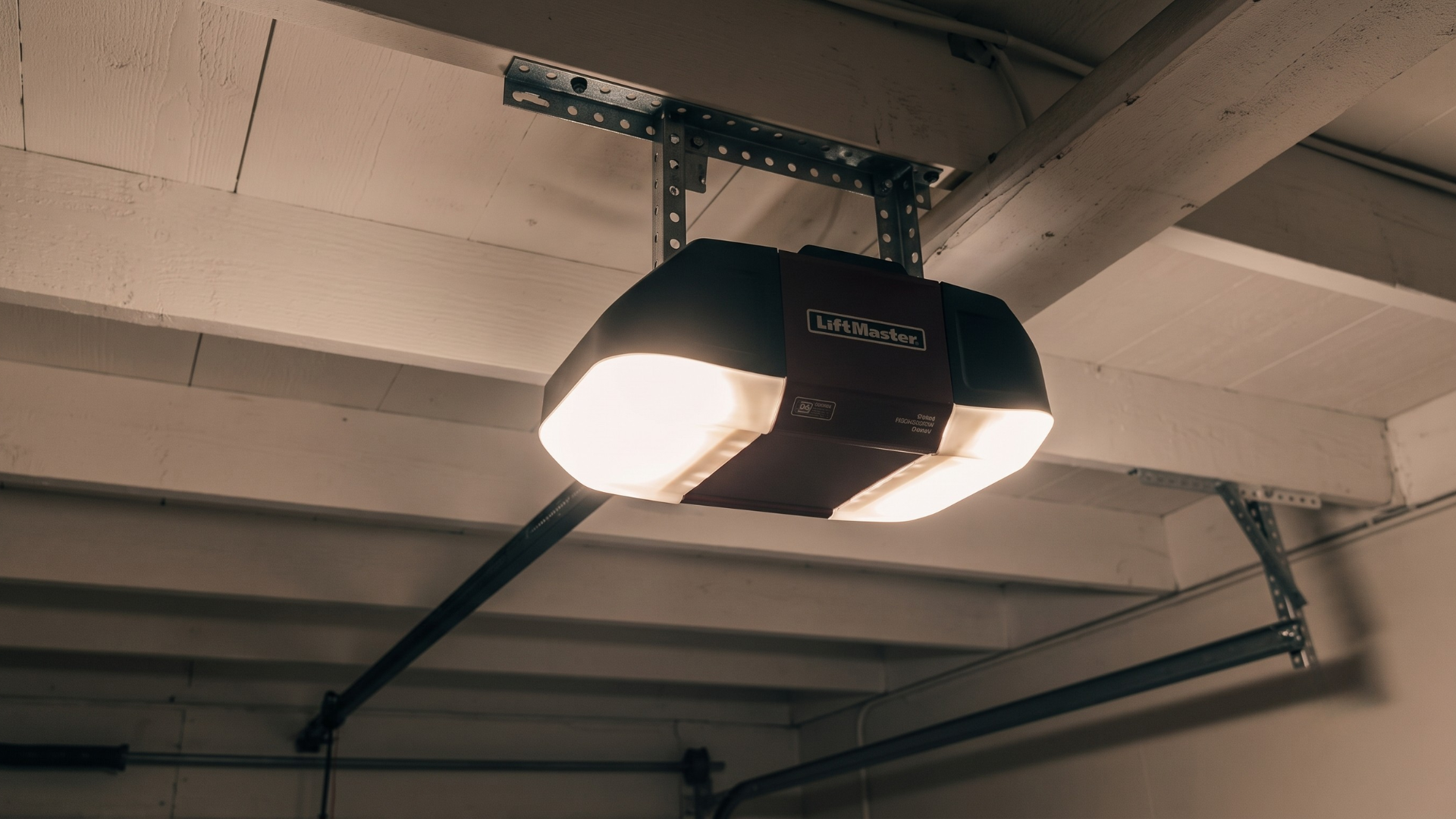 Garage ceiling with a black garage door opener and two lit lights