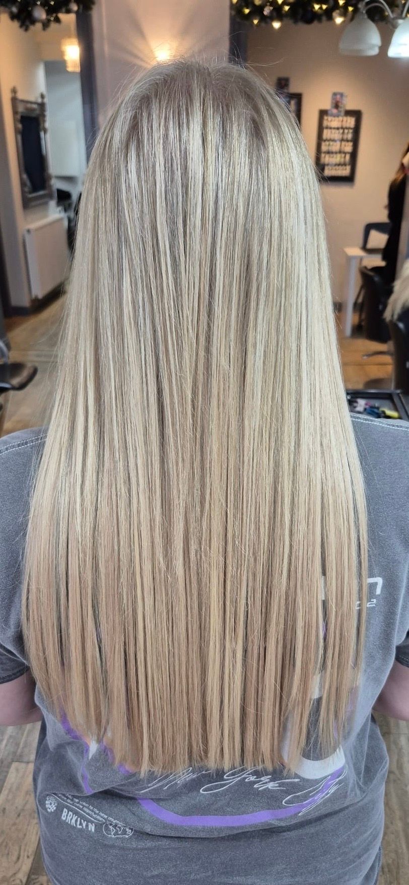 Full length of straight blonde salon hair with softly blended highlights
